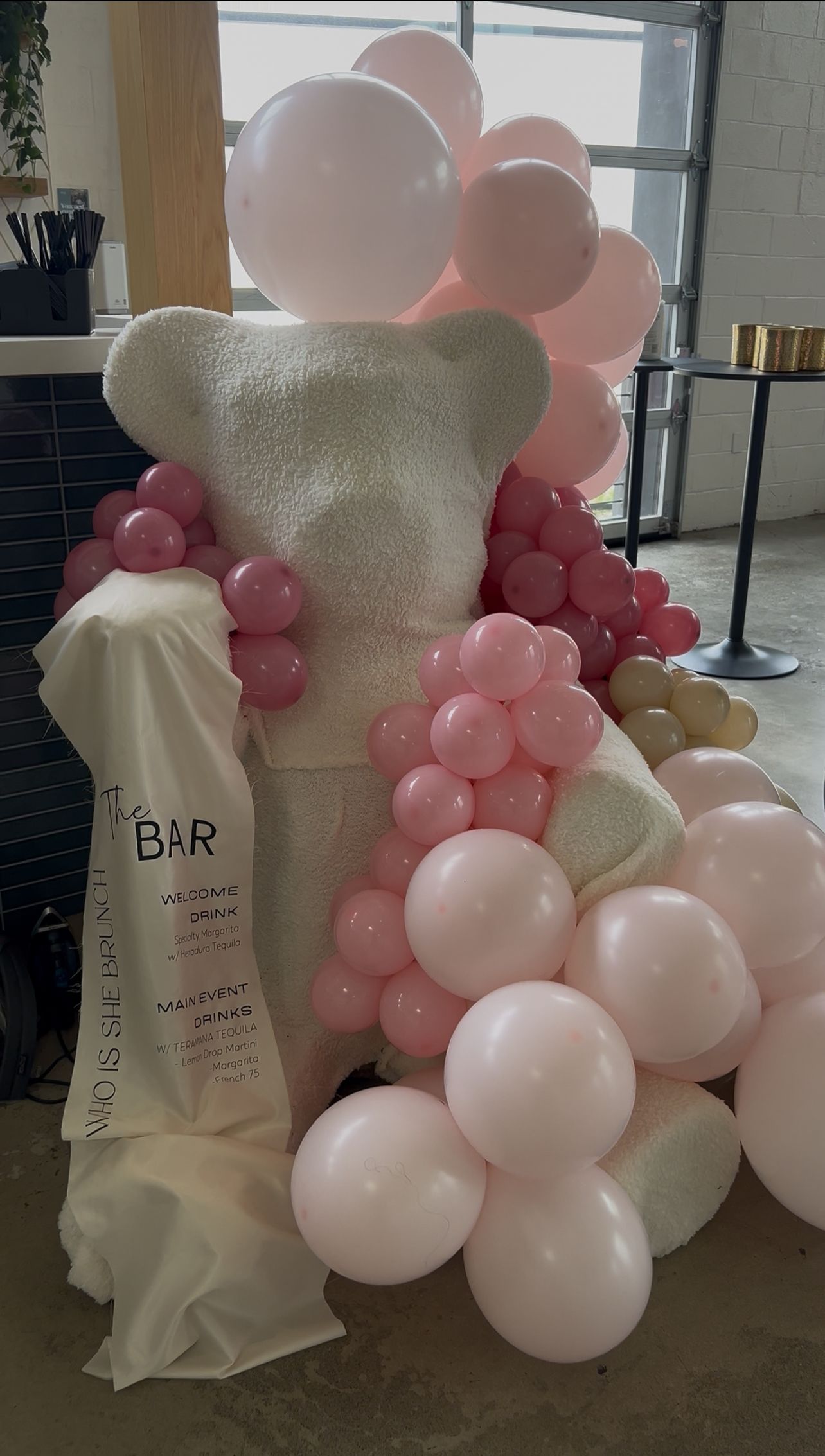Oversized teddy bear balloon display with custom bar sign for Who Is She Brunch