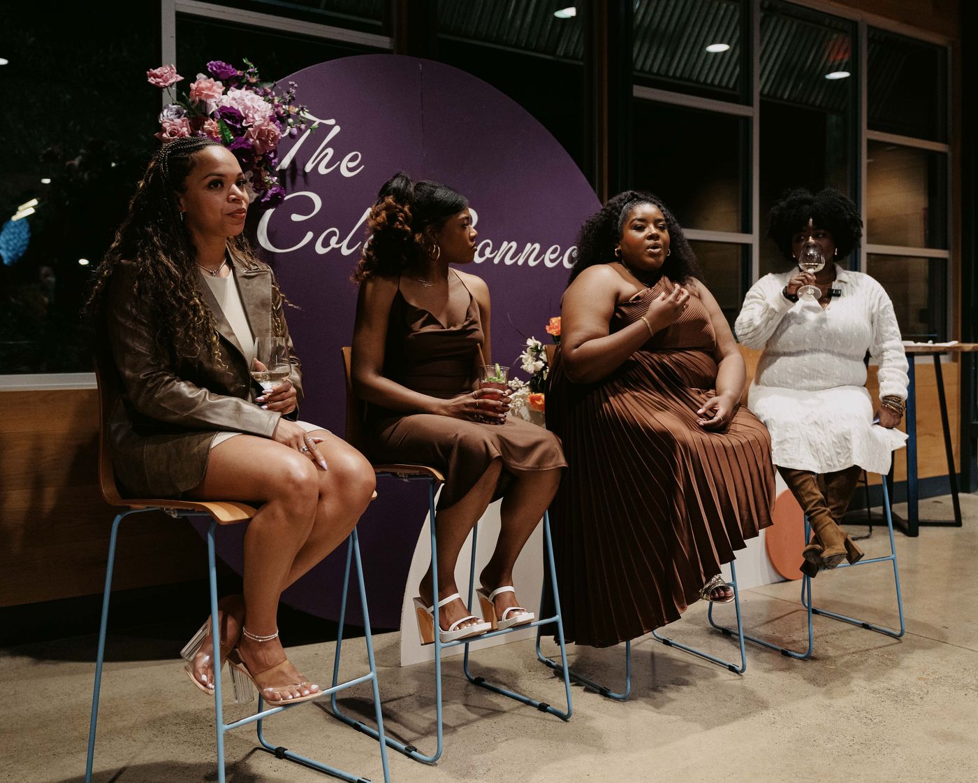 Panel discussion styled with florals and balloon accents at The Color Connect