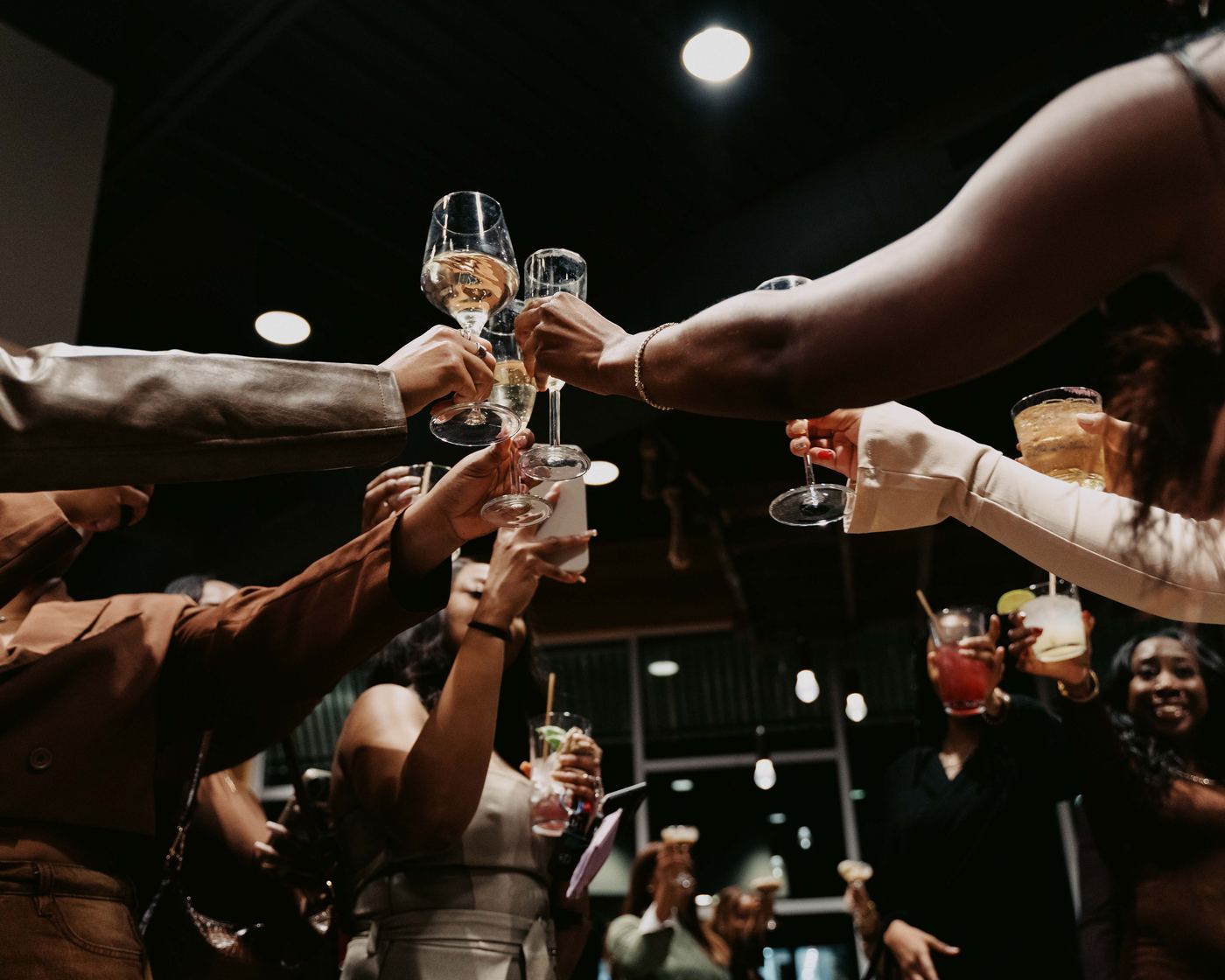 Guests raising a champagne toast at a Posh Party Productions event